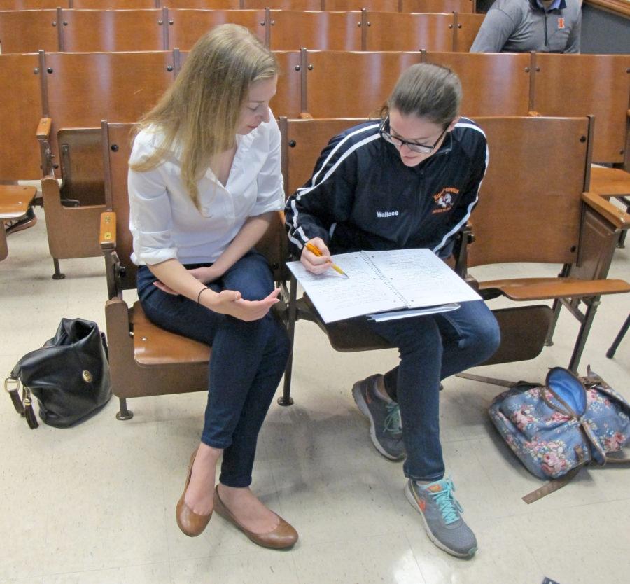 A T.A. helps a student prepare for her History of Photography midterm exam. 