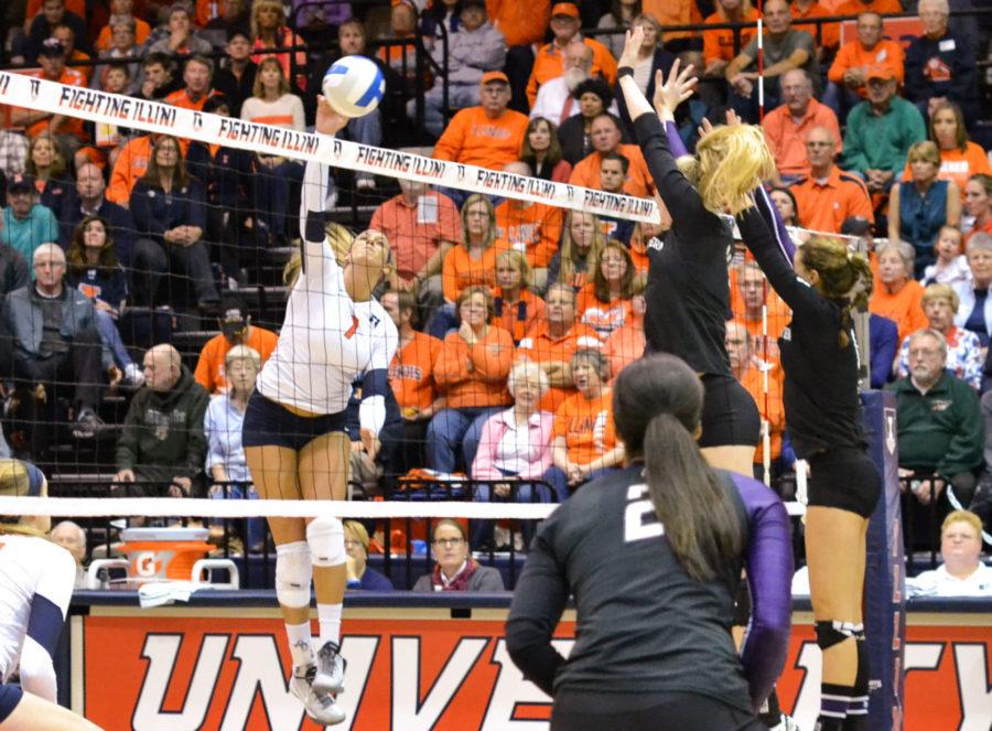 Illinois’ Jocelynn Birks spikes the ball past Northwestern’s block during the volleyball game versus Northwestern at Huff Hall on Saturday. Birks is on pace to break the program record for kills at Illinois.