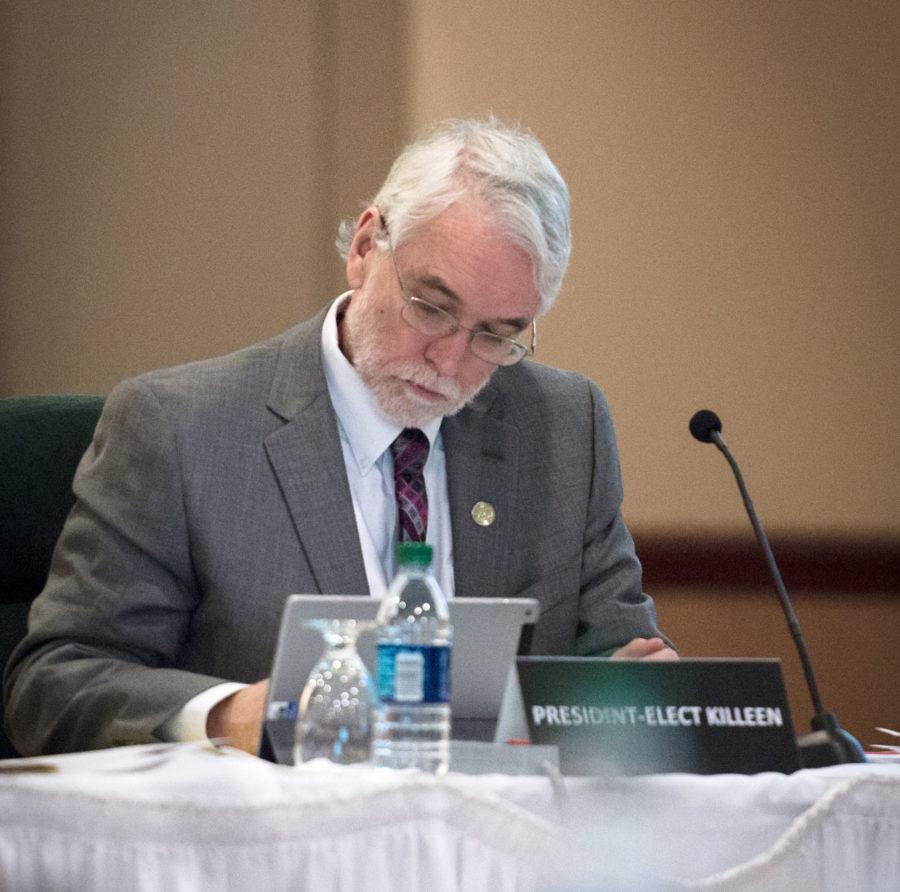 President Timothy L. Killeen takes notes during the board of trustees meeting at the Illini Union on March 12, 2015. Killeen announced  recently that he is confident the University will return to face-to-face instruction in the fall.