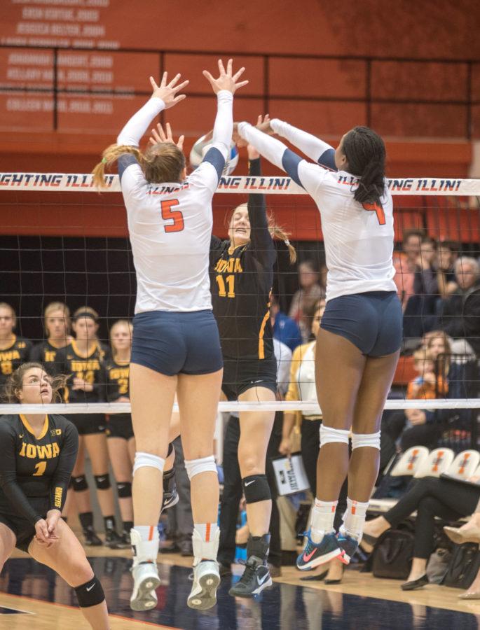 (right) Naya Crittenden stuffs an Iowa attack during Illinois 3-0 win at Huff Hall on Friday.