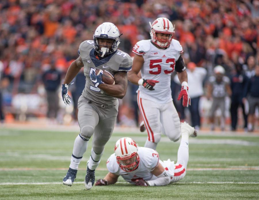 Illinois running back KeShawn Vaughn makes a long run culminating in a touchdown against Wisconsin during the Homecoming game at Memorial Stadium on Saturday. Illinois lost 13-24.