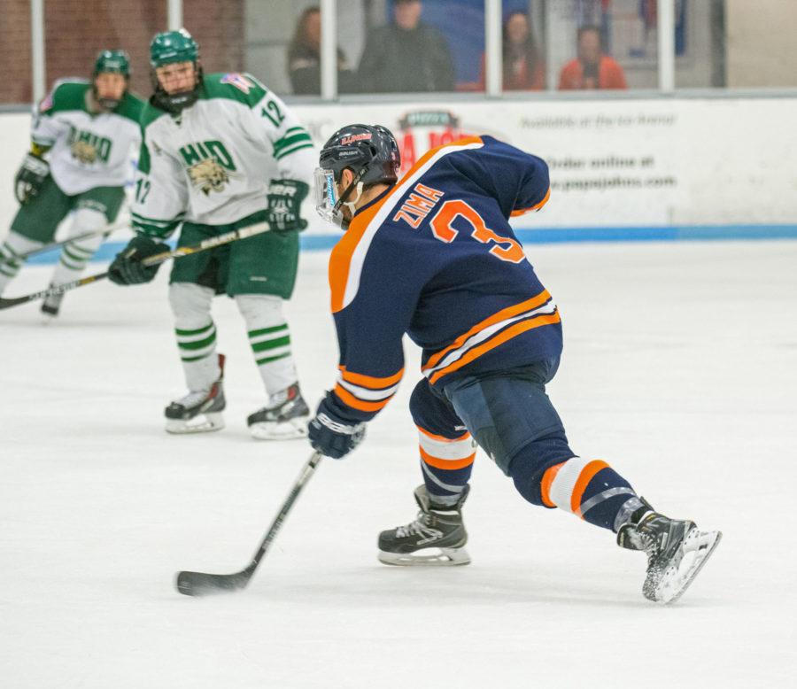 Defenseman Austin Zima fires a shot on goal during the game against Ohio University at the Ice Arena on Saturday, October 24. Illinois lost 2-3 in the shootout.