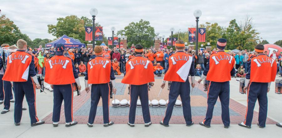 The Marching Illini drumline perform for the crowd gathered at Grange Grove before the game.