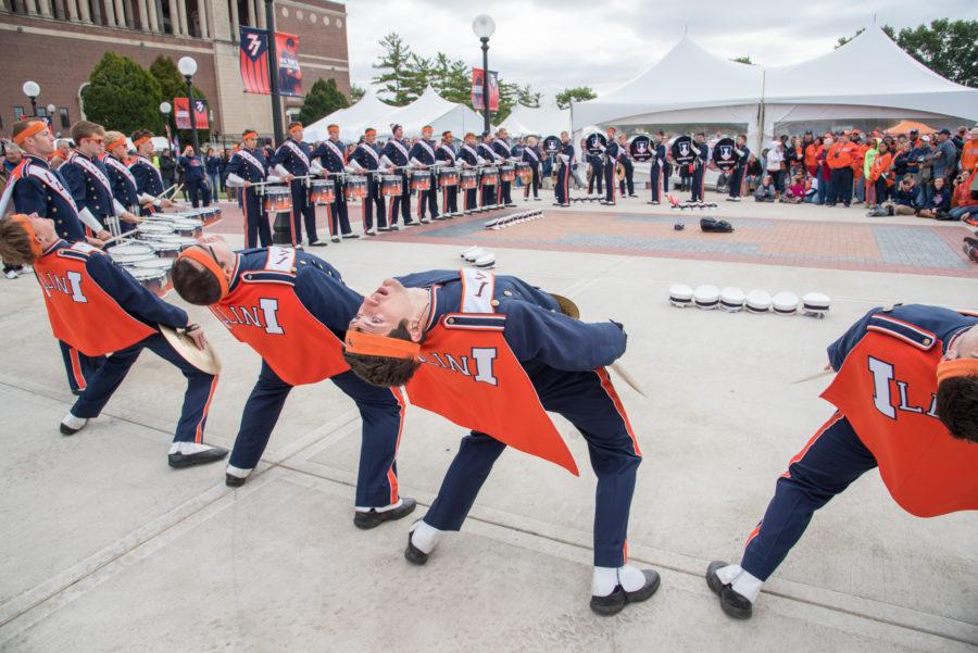 The Marching Illini drum-line performs for fans in Grange Grove before the game.