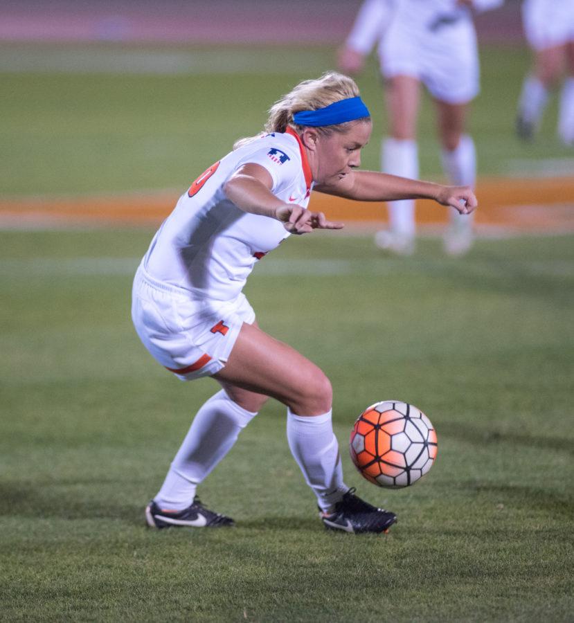 Katie Murray tries to dribble around a defender during the game against Iowa at Illinois Soccer and Track Stadium on Thursday, October 15. Illinois lost 0-1.