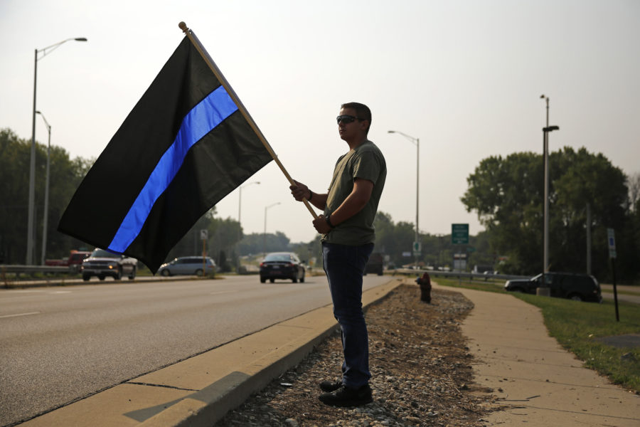 Explorer Devan Arbay, 17, holds a black and purple flag to honor Fox Lake Lt. Charles Joseph G.I. Joe Gliniewicz on the 100 block of U.S. Hwy. 12 on Wednesday, Sept. 2, 2015 in Fox Lake, Ill. When asked why he was here, Arbay said, To show the law enforcement community they are not alone. Gliniewicz was Arbays instructor in the explorers program. (Stacey Wescott/Chicago Tribune/TNS) 