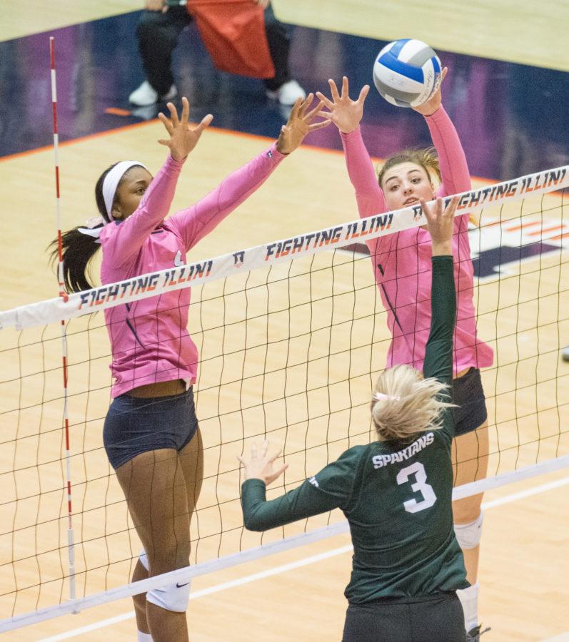 (left) Naya Crittenden and (right) Ali Bastianelli jump to block and attack during the game against Michigan State at Huff Hall on Friday, Oct. 30. Illinois won 3-1.