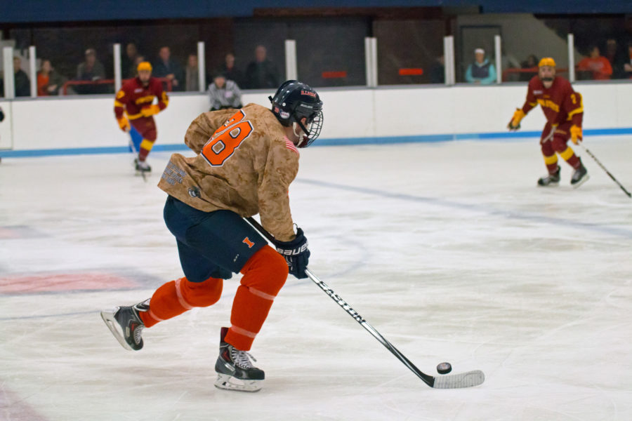 Aaron Dusek carries the puck up the ice during the game at the Ice Arena against Iowa State on Friday, November 13. Illinois won 4-3 in a shootout.