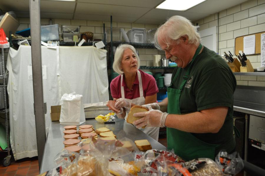 Volunteers Karen Pickard and Joe Finnerty have fun while making sandwiches for patrons at the Daily Bread Soup Kitchen on Nov. 10, 2015.