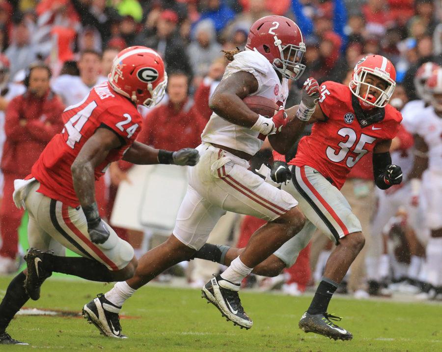 Alabama running back Derrick Henry, middle, breaks away from Georgia defenders Dominick Sanders (24) and Aaron Davis (35) for a touchdown in the first half on Saturday, Oct. 3, 2015, at Sanford Stadium in Athens. Alabama won, 38-10. (Curtis Compton/Atlanta Journal-Constitution/TNS)