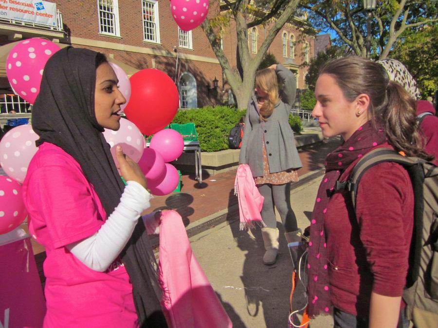 (left) Zahra Siddiqui, sophomore in LAS, explains the history and meaning behind the hijab, or headscarf worn by Muslim women, to (right) Jett Levin, freshman in LAS, on the Quad as part of a series of events sponsored by the UIUC Muslim Students Association to celebrate Islamic Awareness Week 2012. 