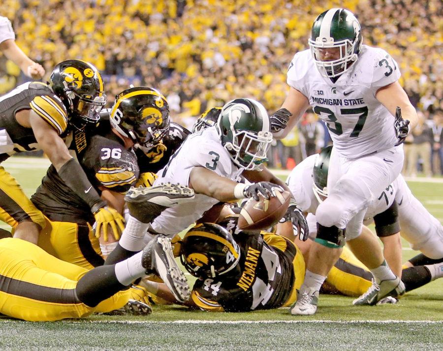 Michigan State running back LJ Scott (3) dives in for a touchdown during the fourth quarter against Iowa in the Big Ten Championship at Lucas Oil Stadium in Indianapolis on Saturday, Dec. 5, 2015. The Spartans won, 16-13. (Kirthmon F. Dozier/Detroit Free Press/TNS)