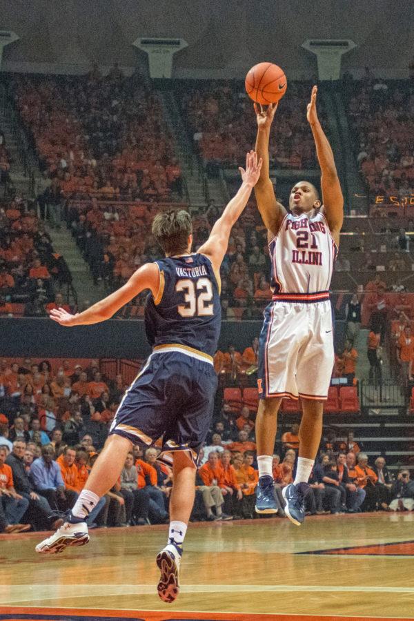 Guard Malcolm Hill takes a three point shot during the game against Notre Dame at the State Farm Center on Wednesday, Dec. 2. Illinois lost 84-79.