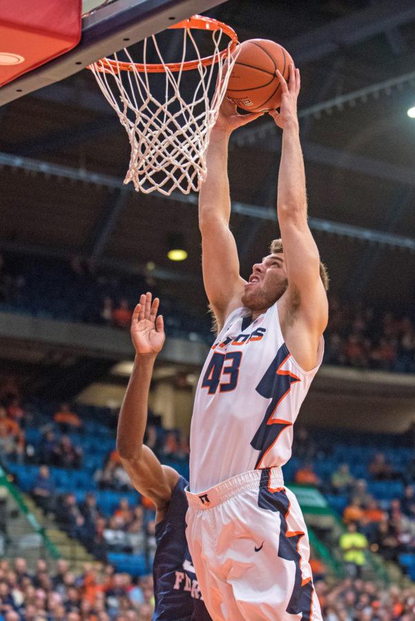 Forward Michael Finke jumps to dump the ball during the game against North Florida at the Prairie Capitol Convention Center on Friday, Nov. 13. Illinois lost 93-81.