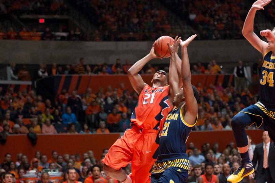 Malcolm Hill puts up a shot that Michigans Mark Donnal (34) is coming in to block during Illinois 78-68 loss to the Wolverines at State Farm Center on Wednesday.