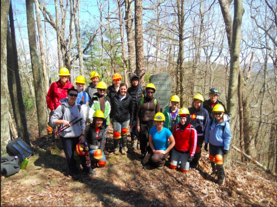 A team pauses to take a photo break after working to clean up hiking trails in Tellico Plains, Tenn. in March 2013.