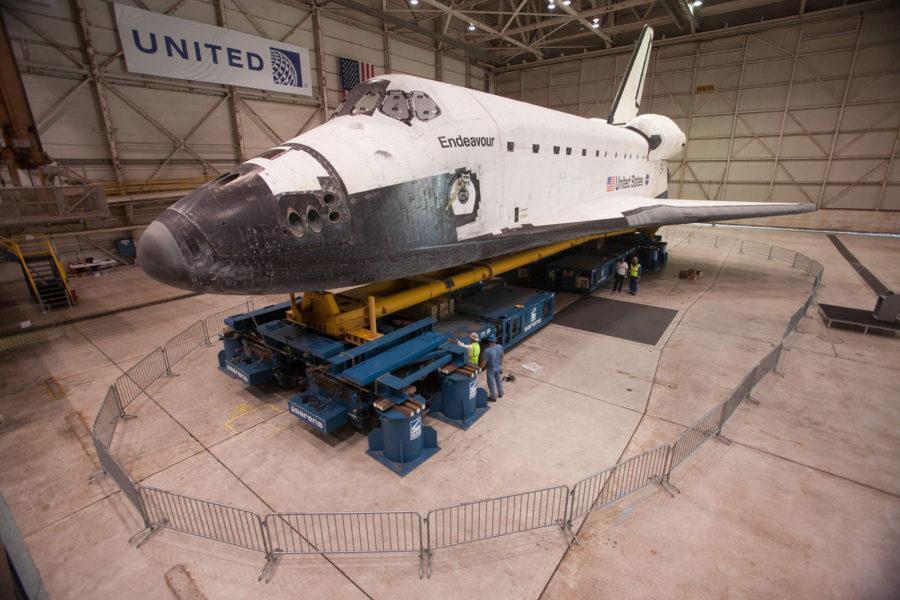 Workers prepare the space shuttle Endeavour for its two–day trek to the California Science Center, Oct. 9, 2012. The orbiter has been stored in the United hangar at Los Angeles International Airport since its arrival. (Bryan Chan/Los Angeles Times/MCT)