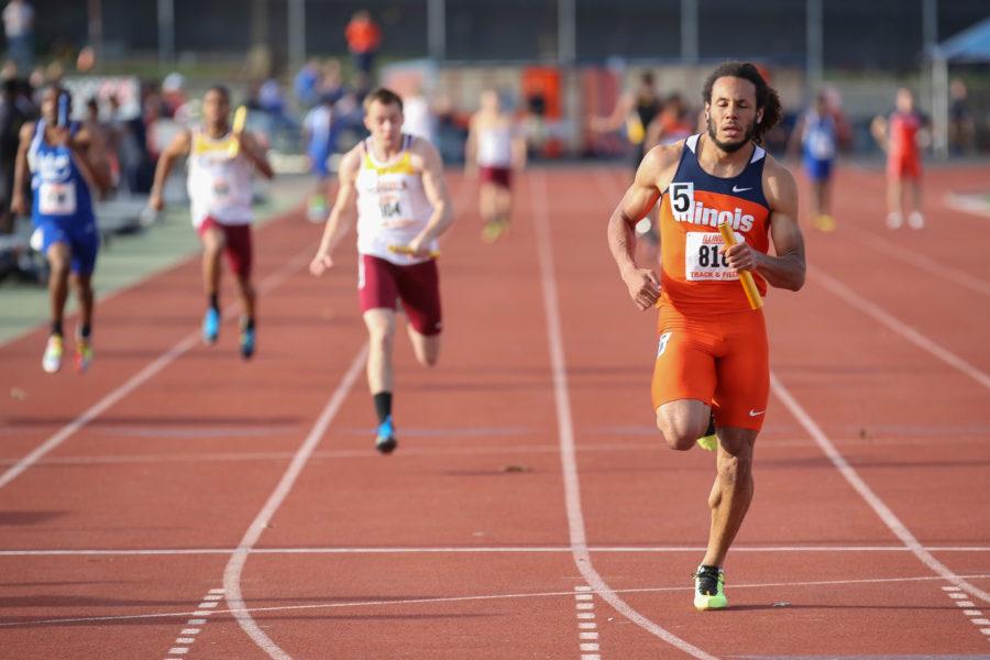 Illinois DJ Zhan crosses the finish line to win the 4x100 meter relay during the Illinois Twilight Track and Field meet at Illinois Soccer and Track Stadium on Saturday, April 12, 2014.