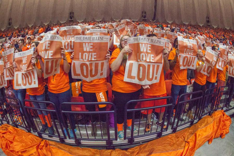 The+Orange+Krush+sport+special+We+Love+Lou%21+newspapers+during+the+pregame+at+State+Farm+Center+honoring+past+Illinois+coach+Lou+Henson+after+who+the+court+is+named.+