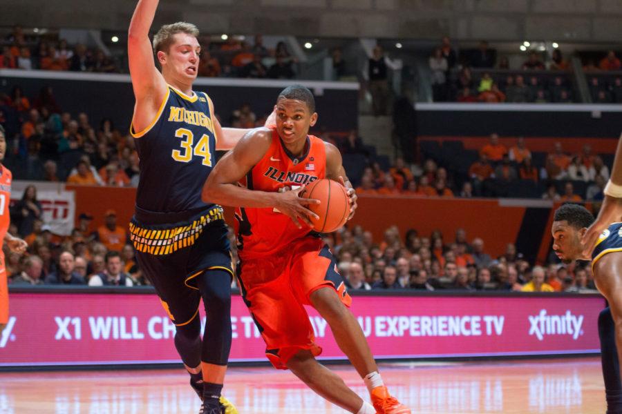 Malcolm Hill driving to the basketball against Michigans Mark Donnal during Illinois 78-68 loss to the Wolverines at State Farm Center on Wednesday.