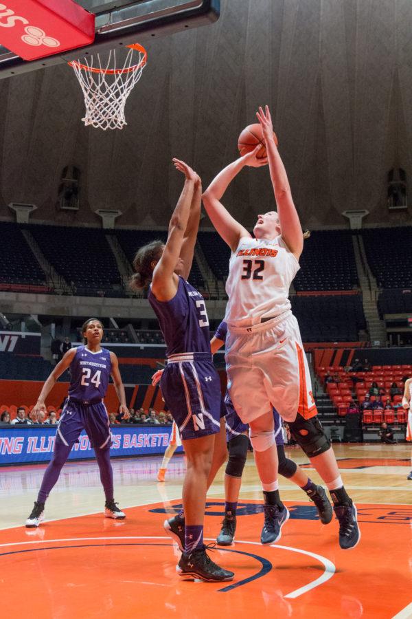Illinois Chatrice White takes a layup over Northwesterns Pallas Amber Jamison during the game against Northwestern at the State Farm Center on February 4. The Illini lost 69-59.