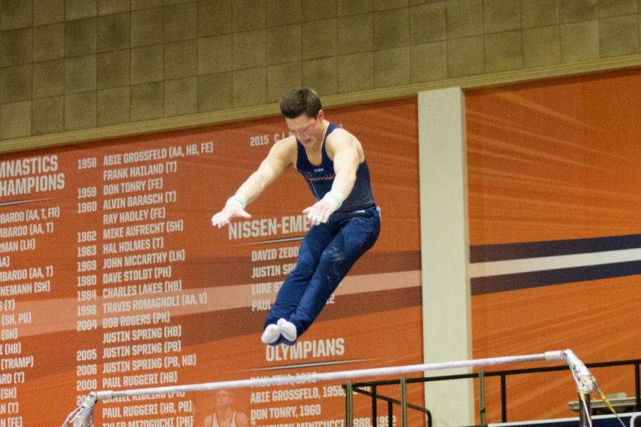 Illinois Alex Diab performs a routine on the high bar during the meet against Temple & UIC at Huff Hall on Saturday, Feb. 6, 2016.