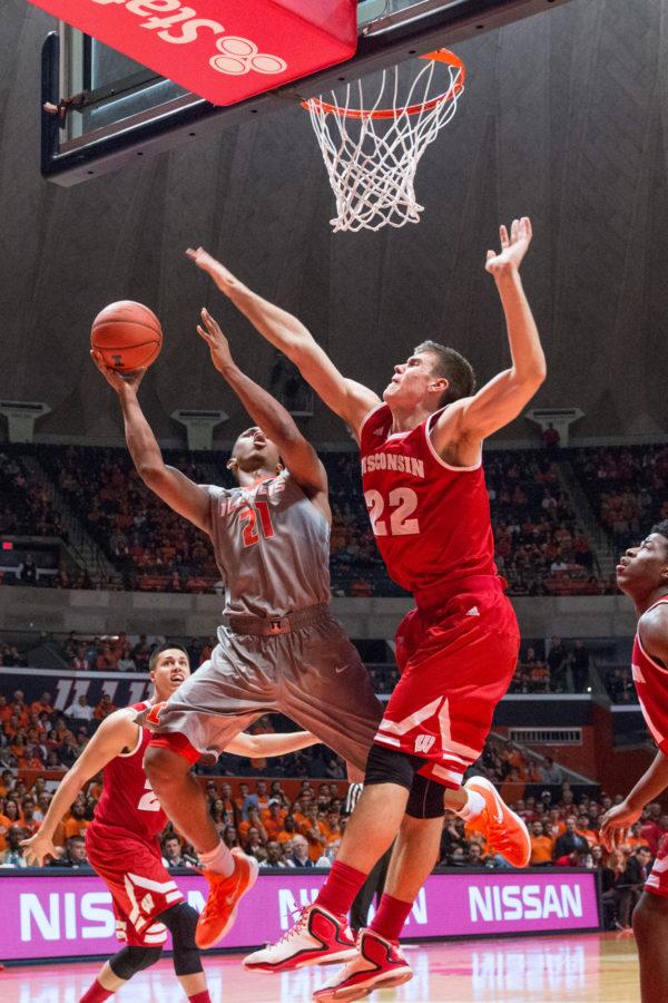 Illinois Malcolm Hill shoots a layup over Wisconsins Ethan Happ during the game against Wisconsin at the State Farm Center on Sunday, January 31. The Illini lost 63-55.