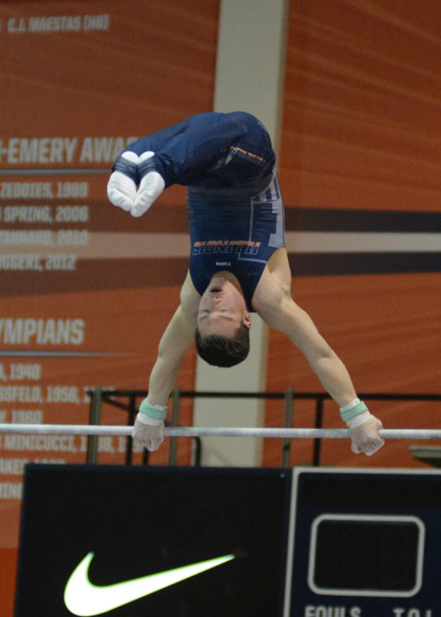 Illinois Alex Diab performs a bar routine during the meet against Temple & UIC at Huff Hall on Saturday, Feb. 6, 2016.
