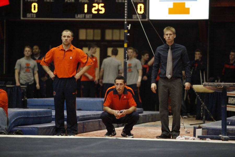 Daryl Quitalig The Daily IlliniIllinois head coach Justin Spring, right, watches ___ floor routine during the Gym Jam at the Huff Hall on Friday, March 2, 2012.