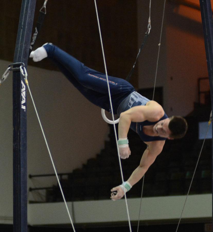 Illinois Alex Diab attempts a dismount during his ring routine in the meet against Temple & UIC at Huff Hall on Saturday, Feb. 6, 2016.