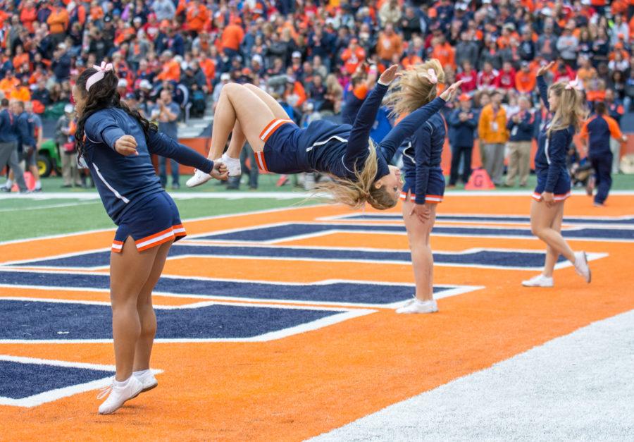 Illini cheerleaders flip after an Illinois score during the Homecoming game against Wisconsin at Memorial Stadium on Saturday, October 24. Illinois lost 13-24.