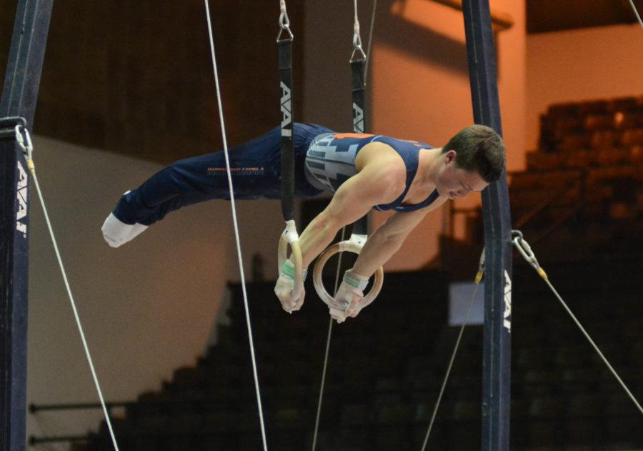 Illinois Alex Diab attempts a dismount during his ring routine in the meet against Temple & UIC at Huff Hall on Saturday, Feb. 6, 2016.