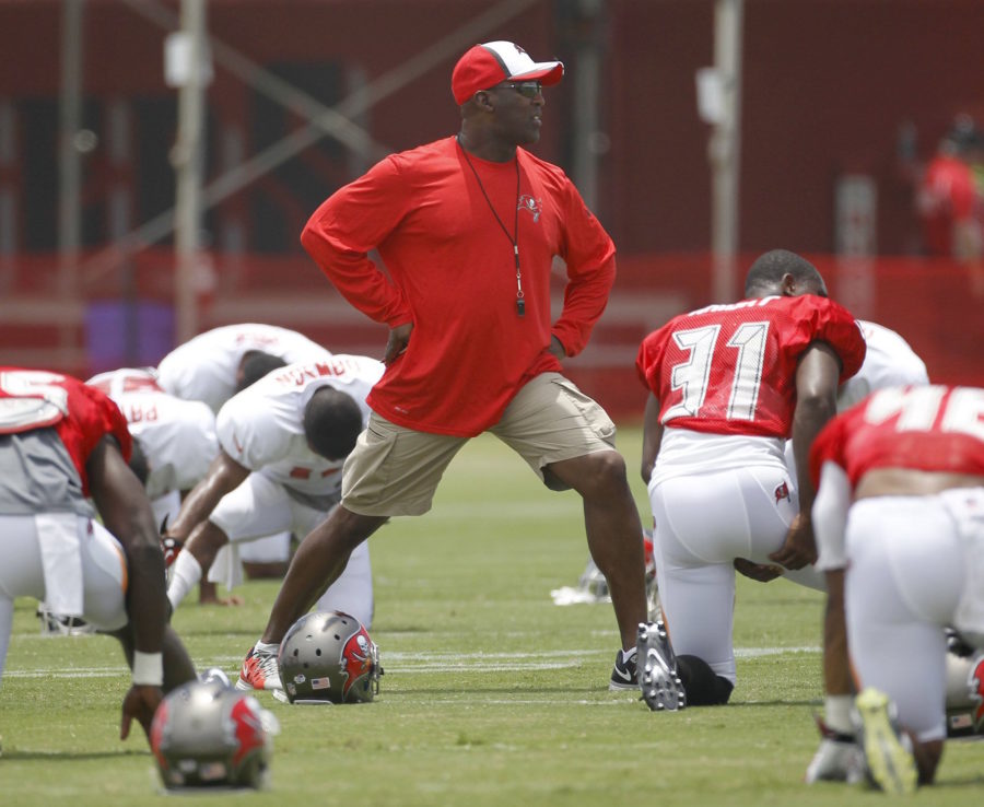 Tampa Bay Buccaneers head coach Lovie Smith stretches during Bucs training camp at One Buc Place in Tampa, Fla., Monday, July 28, 2014. (James Borchuck/Tampa Bay Times/MCT)