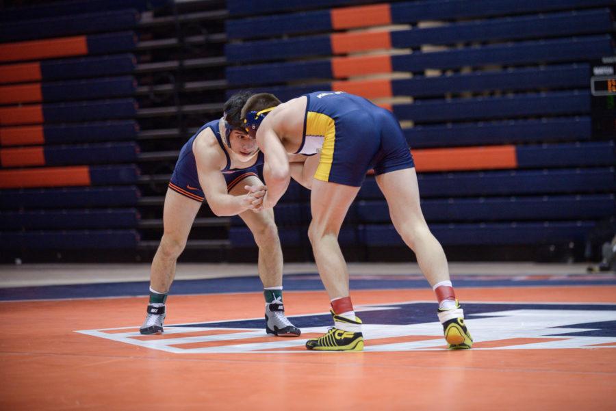 Illinois Isaiah Martinez looks for an opportunity against Kent States Ian Miller during the match at Huff Hall on Sunday, February 15, 2015.The Illini won 38-0.