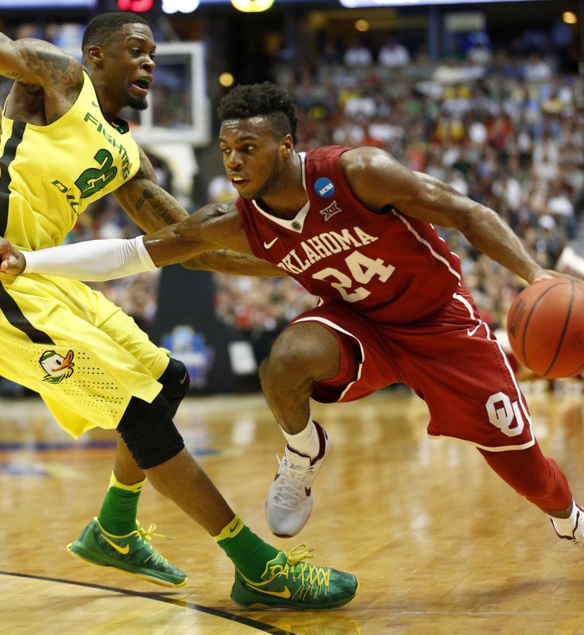 Oklahoma's Buddy Hield, right, drives to the basket against Oregon's Elgin Cook during the first half in the finals of the NCAA Tournament's West region at the Honda Center in Anaheim, Calif., on Saturday, March 26, 2016. Oklahoma advanced, 80-68. (Luis Sinco/Los Angeles Times/TNS)