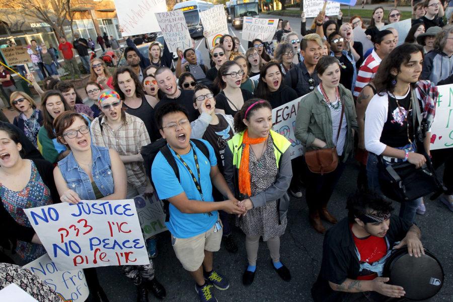 Protesters chant at the intersection of Franklin and Columbia Streets, where they formed a circled and stopped traffic for hours in Chapel Hill, N.C., on Tuesday, March 29, 2016, to protest the recent passage of N.C. HB2. (Chris Seward/Raleigh News & Observer/TNS)