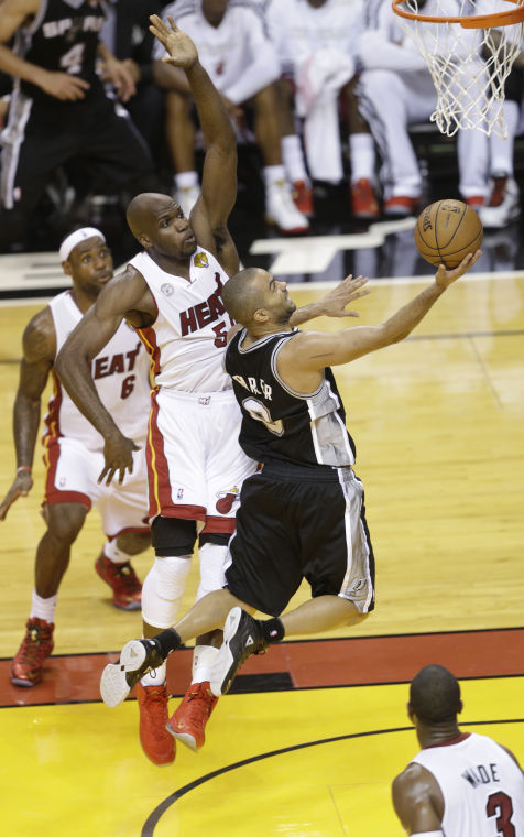 San Antonio Spurs point guard Tony Parker (9) shoots against Miami Heat center Joel Anthony (50) during the first half of Game 1 of basketballs NBA Finals, Thursday, June 6, 2013 in Miami.
