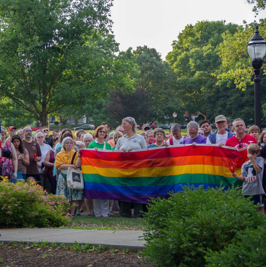 Community members listen speakers and gather for support at the Vigil for Orlando at the West Side Park in Champaign on Tuesday, June 14, 2016.
