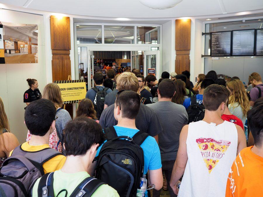 Students attempt to enter the Illini Union Bookstore but are prevented from doing so due to full capacity on Aug. 2.