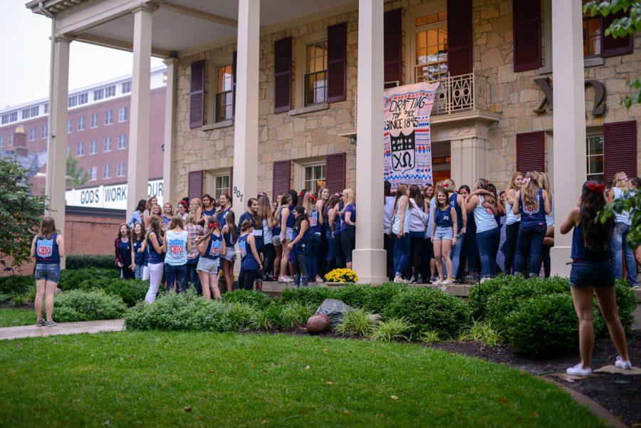 Sisters, joined by pledges, sing their songs on the front porch during Bid Day on Monday, Sept. 15, 2014.