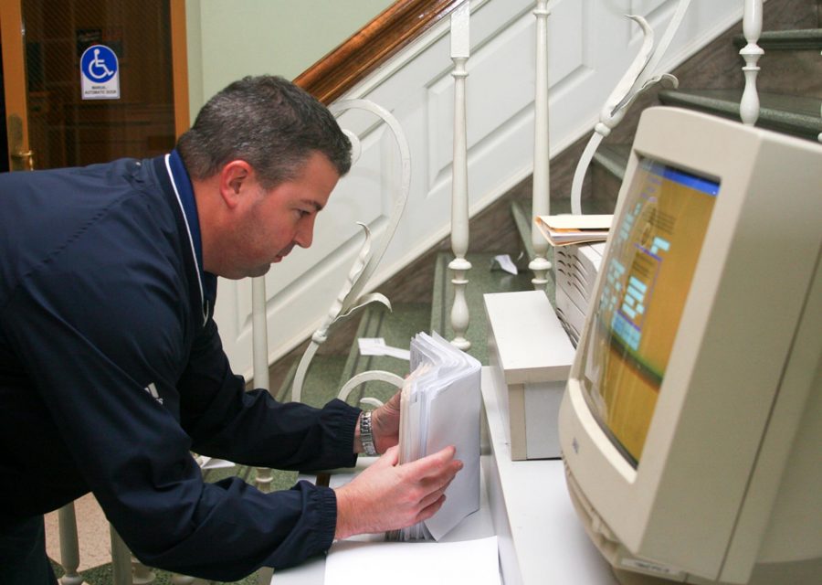 Champaign County Clerk Gordy Hulten collects  and sorts the final voter registration forms for an election in the southeast corner of the Union. 