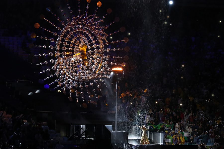 Brazilian singer and actress Mariene de Castro sings as the Olympic flame slowly extinguishes behind her on Sunday, Aug. 21, 2016 at Maracan in Brazil. (Robert Gauthier/Los Angeles Times/TNS)