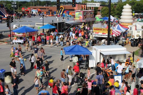 Crowds walk the streets at the Urbana Sweetcorn Festival in downtown Urbana. Imagine Urbana plans to invest in downtown.