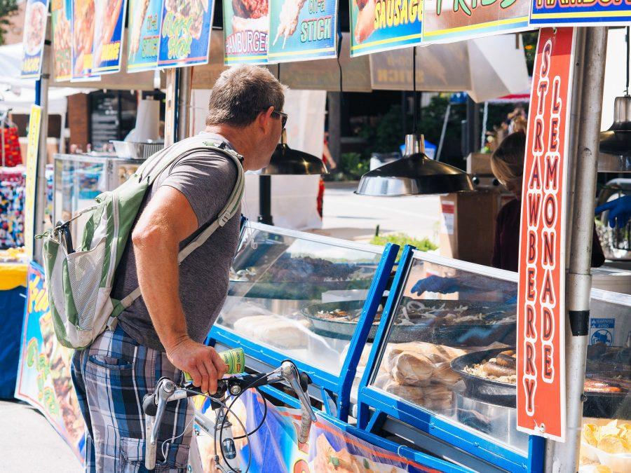 A customer purchases food from festival food vendor. Urbana, IL. August 27, 2016.