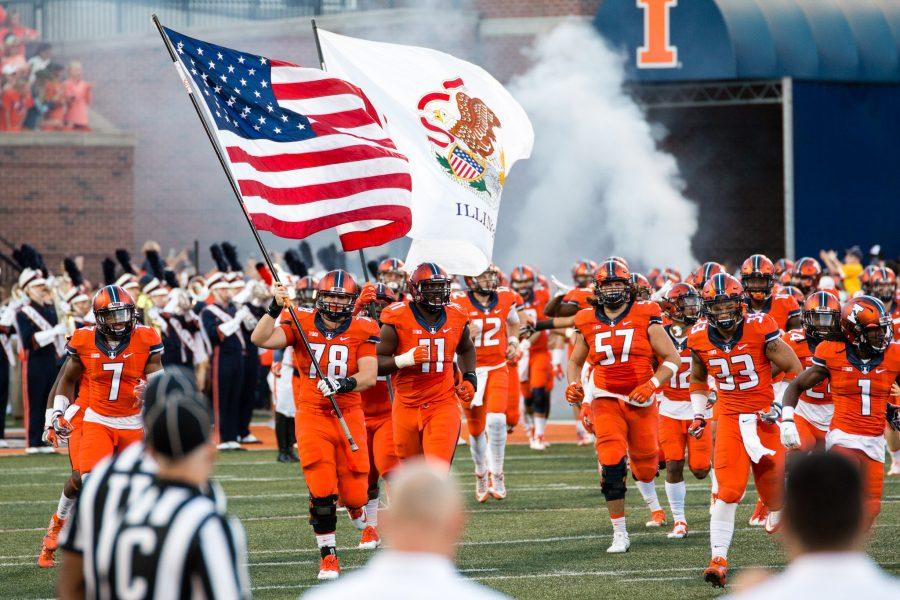 The+Illinois+football+team+runs+onto+the+field+before+the+game+against+North+Carolina+at+Memorial+Stadium+on+Saturday%2C+September+10.+The+Illini+loss+48-23.