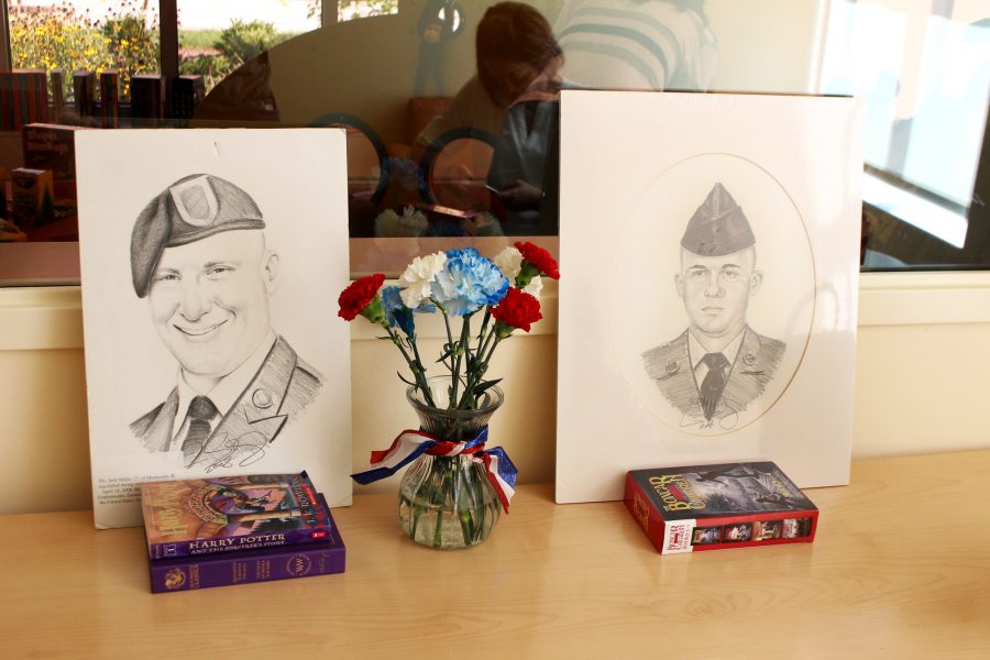 Portraits of Seth Miller and Lucas V. Starcevich sit outside the childrens library dedicated to them.