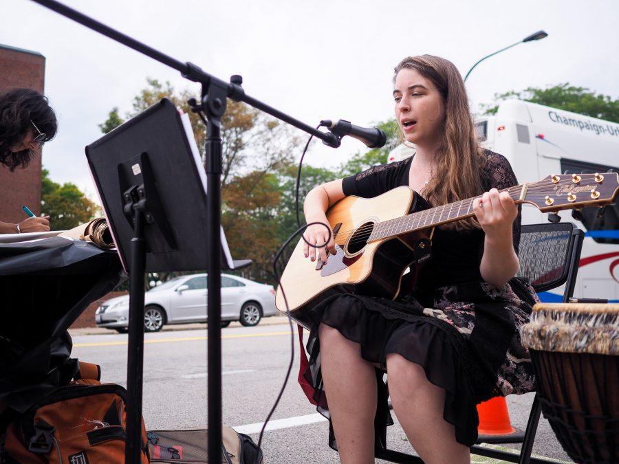 Rachel Wilson, a second year masters student in Urban Planning, performs on Goodwin Avenue for Parking Day in Urbana, IL on September 16, 2016.