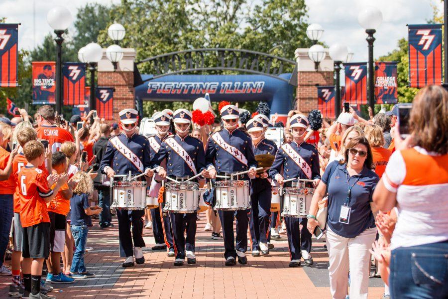 The drum line escorts the football team into Grange Grove before the game against Murray State at Memorial Stadium on Saturday, September 3.