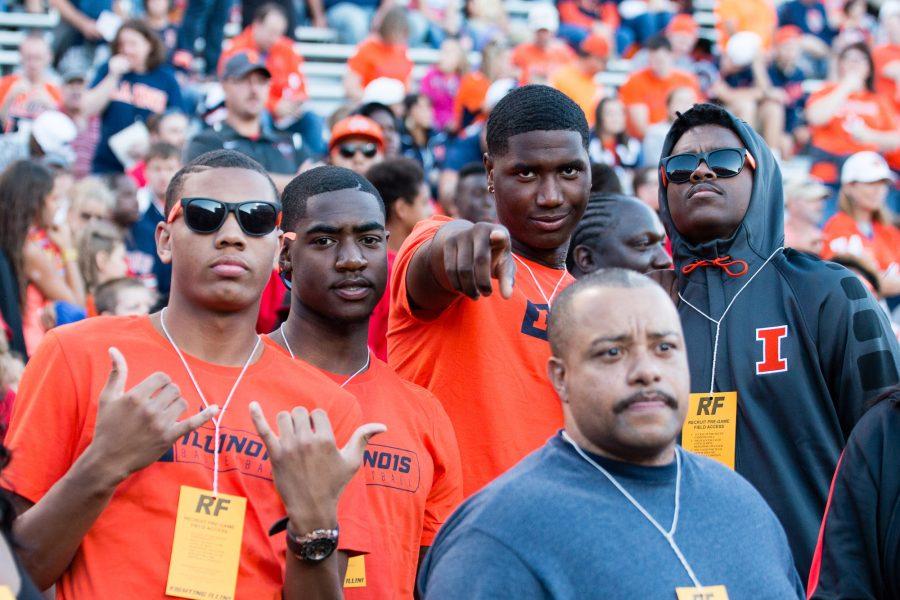 Illinois basketball recruits pose for a photo before the game against North Carolina at Memorial Stadium on Saturday.