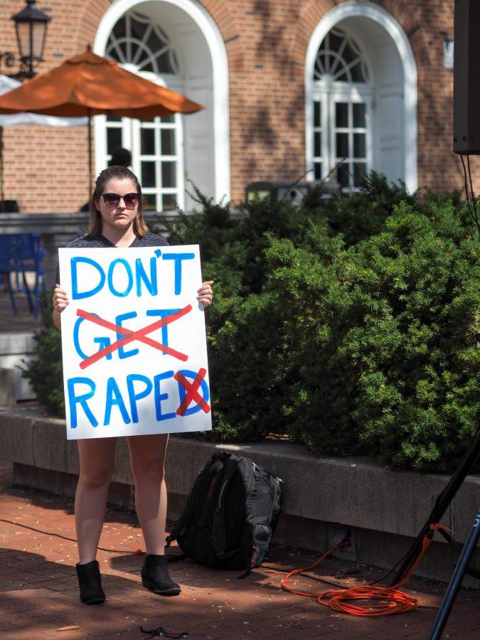 A student holds a sign protesting rape at the Rally Against Rape event.